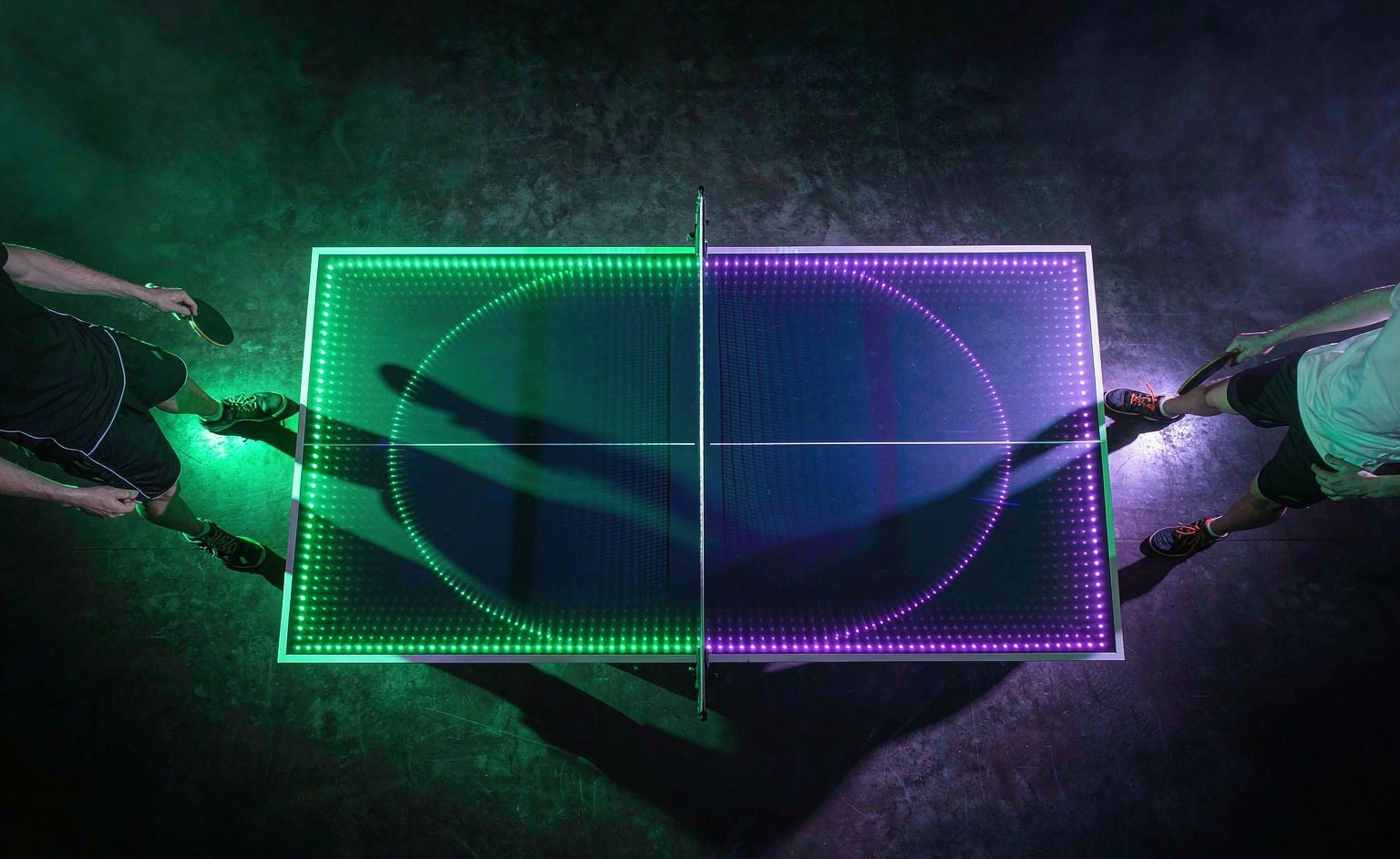 Top-down view of the CYDON PONG interactive LED ping pong table mid-match